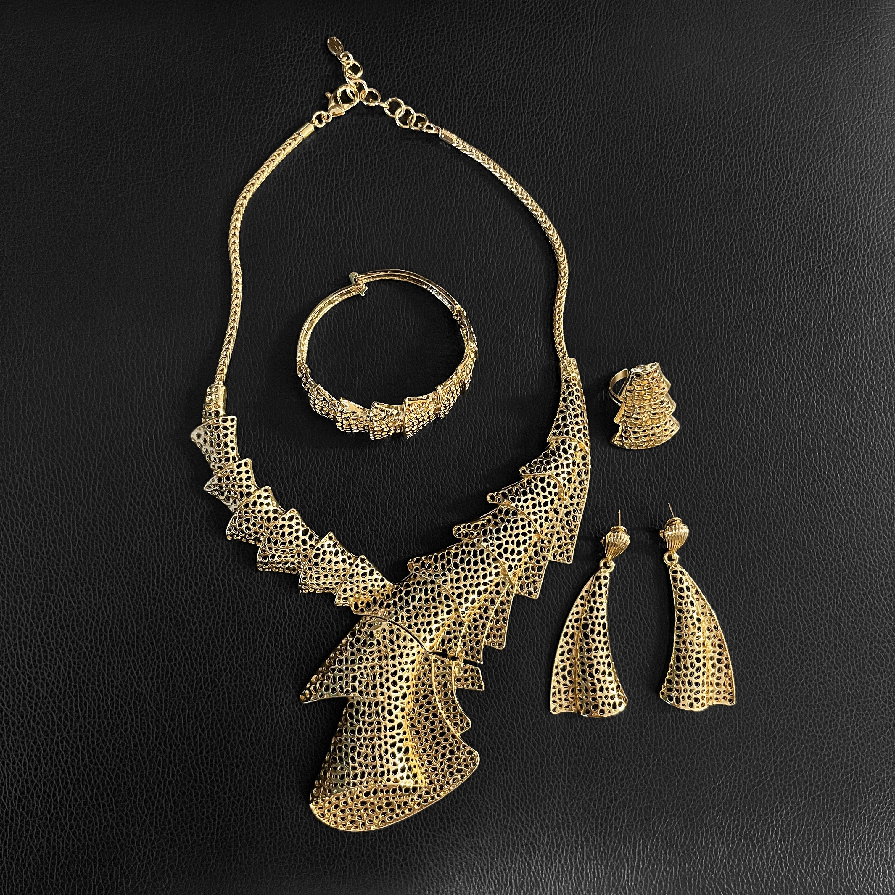 Elegant LAQTA fashion jewelry for women featuring stylish, intricate design with shiny gold and gemstone accents.