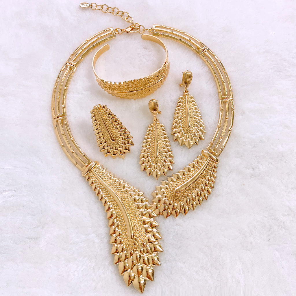 Gold plated Dubai jewelry set by LAQTA featuring intricate designs with necklaces, earrings, and matching accessories.