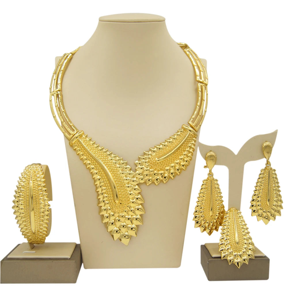 Gold plated Dubai jewelry set by LAQTA featuring intricate design, including necklace and matching earrings, on a white background.