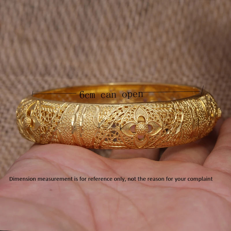 Set of 24k Dubai gold color bangles by LAQTA featuring shiny gold finish and intricate design details.