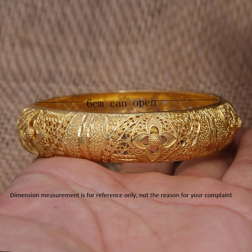 Set of 24k Dubai gold color bangles by LAQTA featuring shiny gold finish and intricate design details.