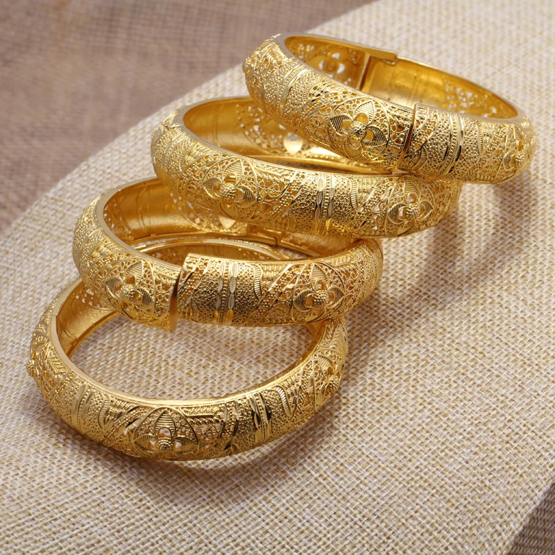 Gold-colored Dubai bangles in 24k gold tone from LAQTA, showcasing a set of elegant, shiny jewelry bangles with intricate design details.