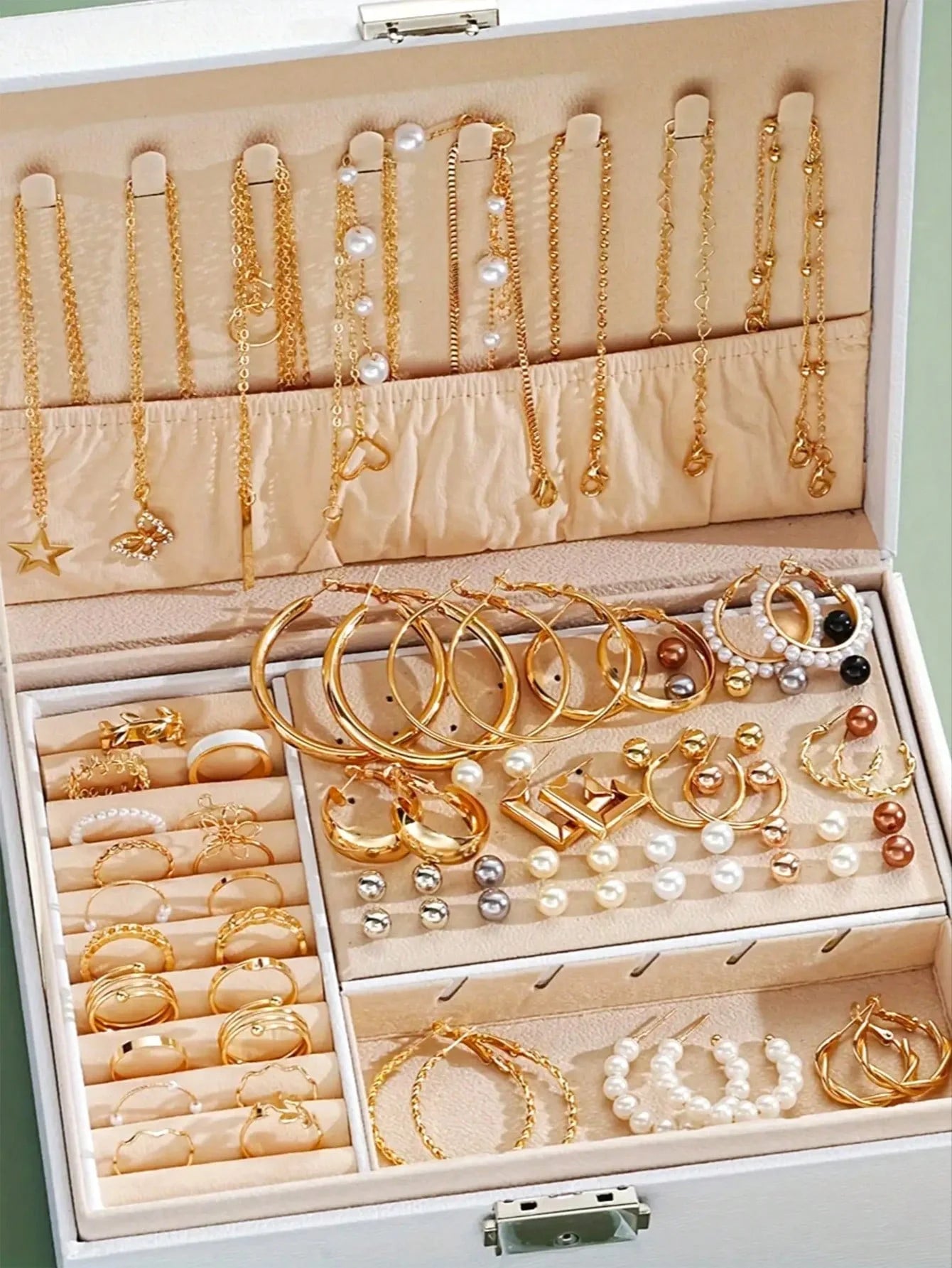 Elegant multi-pearl earrings by LAQTA featuring layered pearl design on silver hooks.