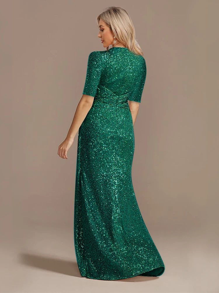 Elegant green evening dress by LAQTA featuring a flowing design and intricate details, perfect for formal occasions.