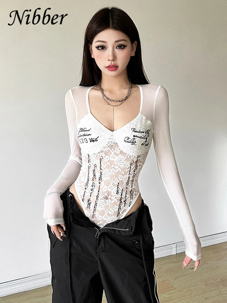 Woman wearing LAQTA letter print bodysuit, showcasing fitted style with bold letter design and long sleeves.