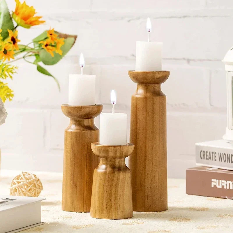 Natural wooden candlestick holders by LAQTA, showcasing sleek, handcrafted designs perfect for decorative candle displays.