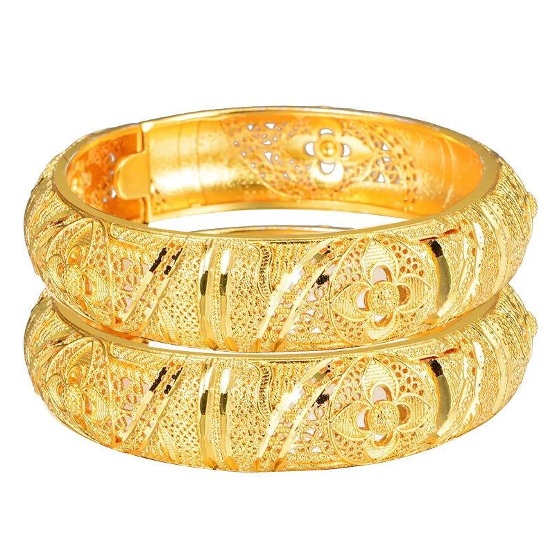 24k Dubai gold color bangles from LAQTA featuring intricate designs and a shiny gold finish, displayed on a white background.