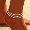 Silver metal pendant anklet by LAQTA featuring intricate design and delicate chain detail.