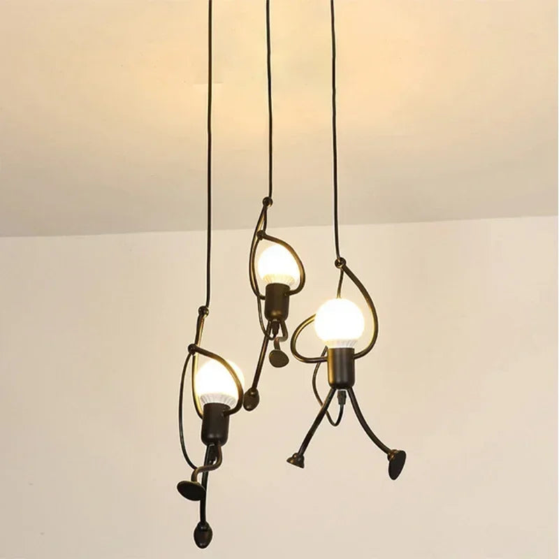 Vintage iron Little Man pendant lights by LAQTA, featuring a rustic design with detailed metal craftsmanship, ideal for modern decor.