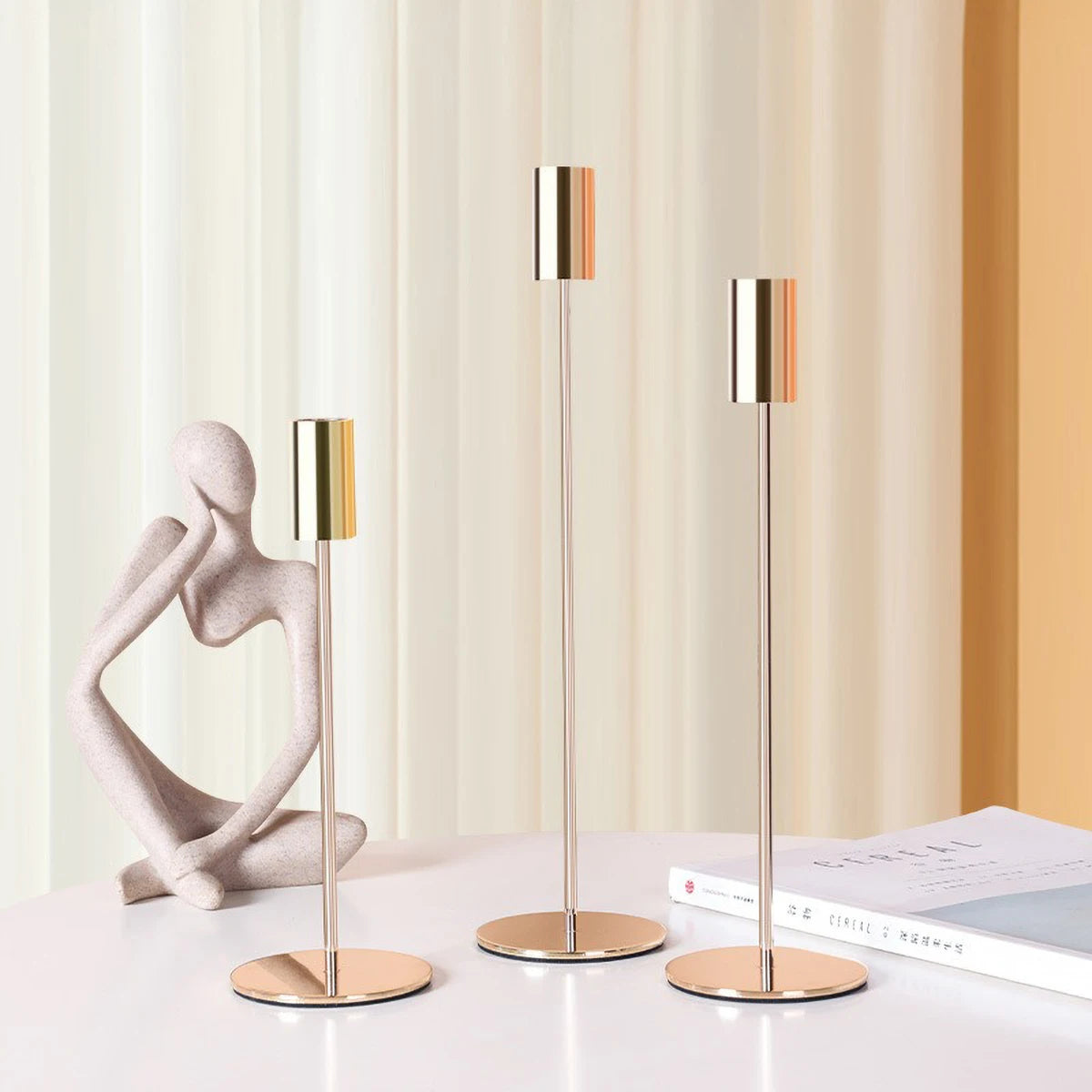 Elegant gold candlestick holder by LAQTA with a sleek design, suitable for decorative or functional display.