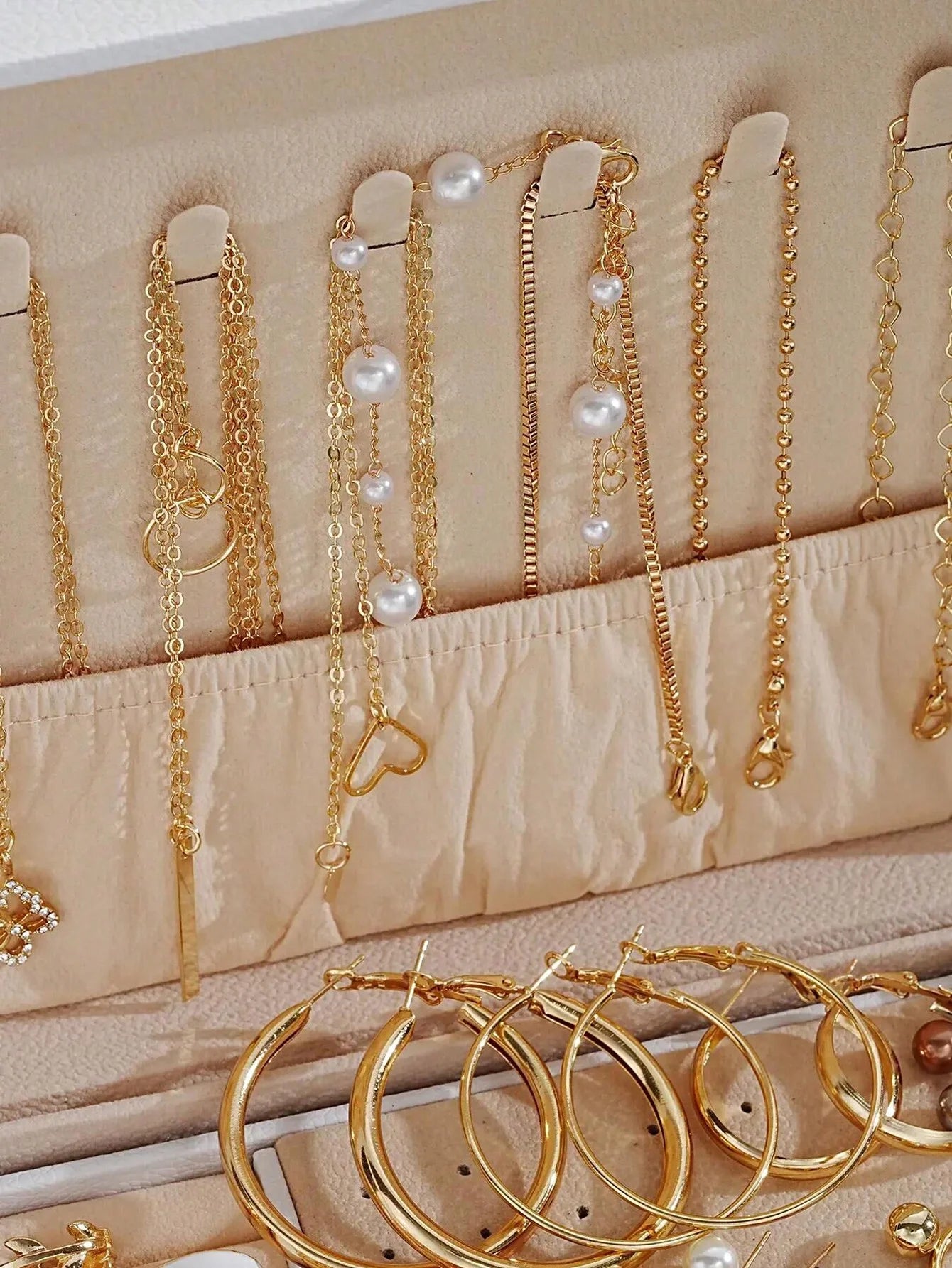 Elegant multi-pearl earrings by LAQTA featuring layered pearl drops with gold accents and a sophisticated design.