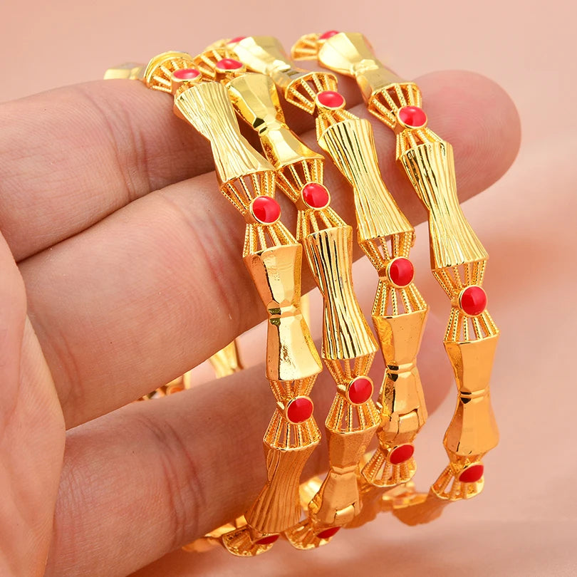 Set of 24k Dubai gold color bangles by LAQTA featuring shiny gold finish and traditional design.