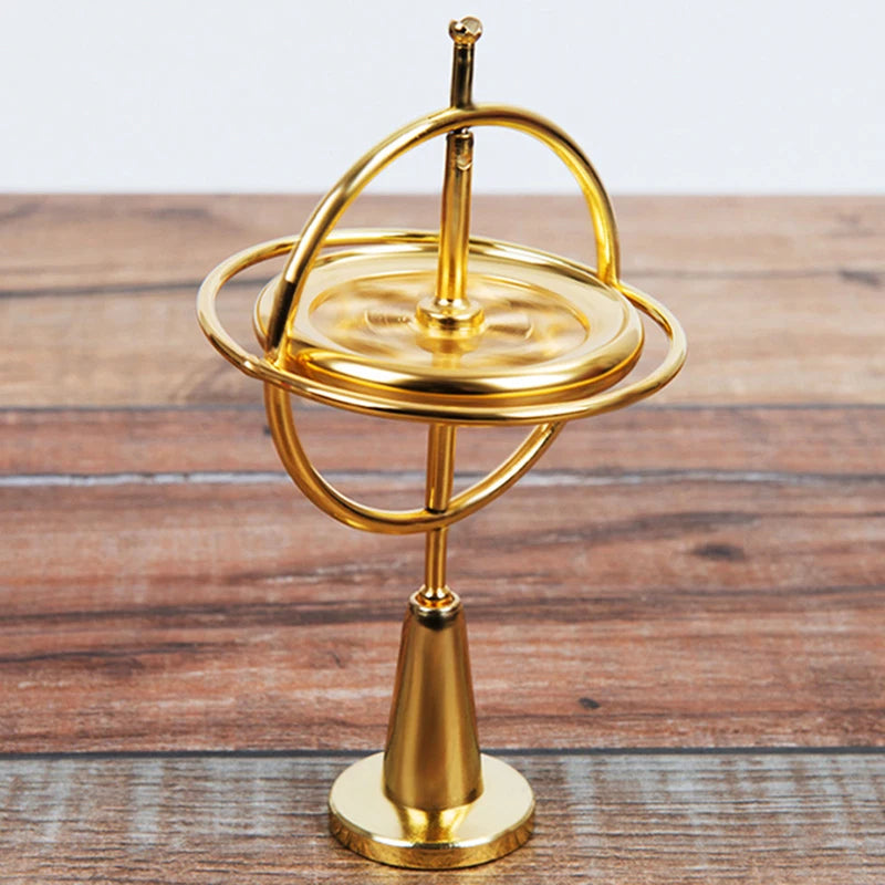 LAQTA Metal Anti-Gravity Spinning toy spinning on a surface with reflective metal finish and intricate design details.