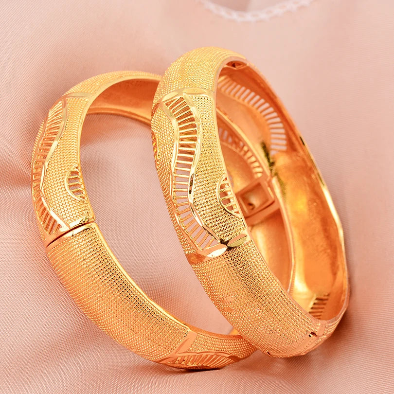 LAQTA 24k Dubai gold color bangles shown in a close-up image, featuring traditional gold design with shiny, polished finish.