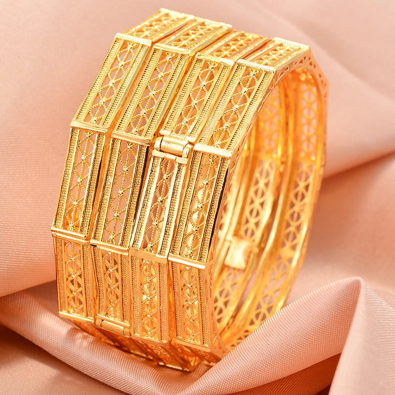 Elegant 24k Dubai gold color bangles from LAQTA, showcasing shiny gold finish and traditional design on a white background.