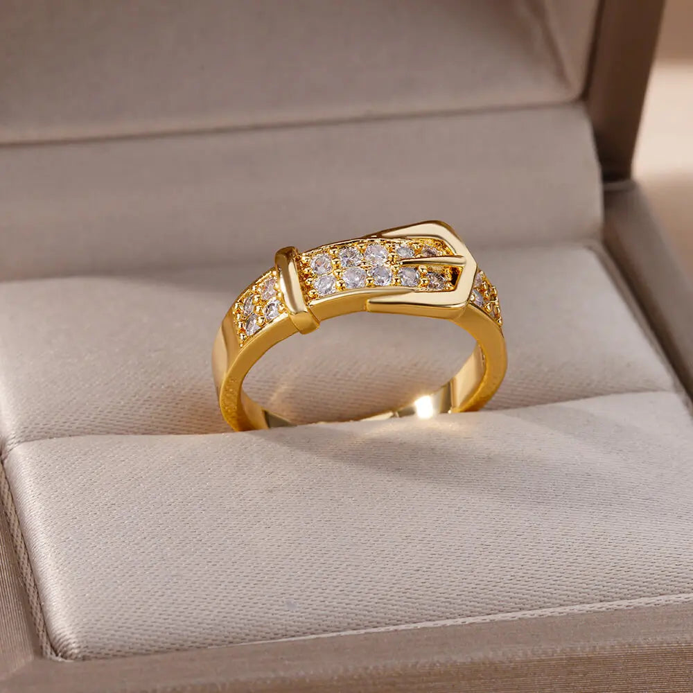 Elegant women's rings by LAQTA featuring intricate designs and shiny silver finish, displayed on a neutral background.