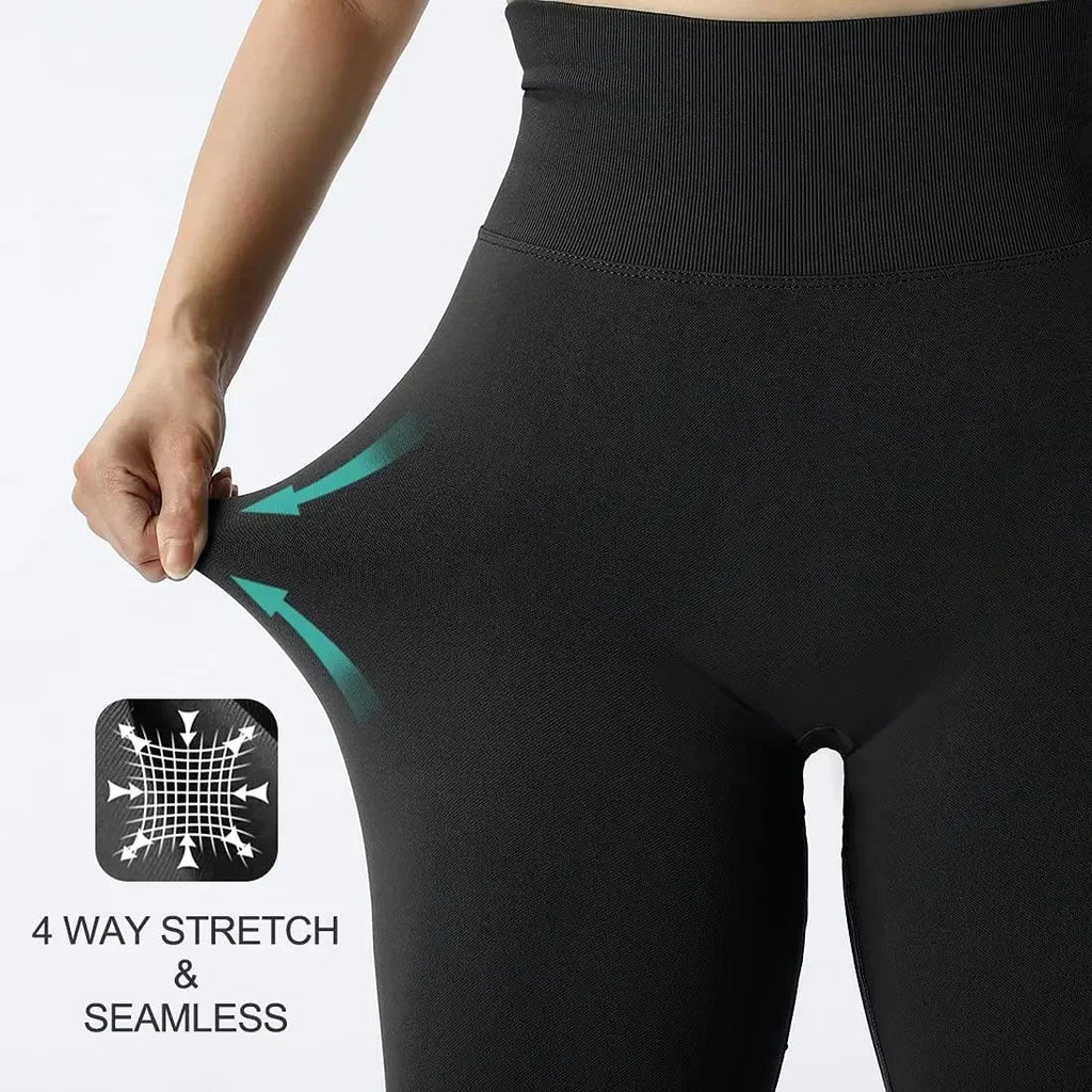 Seamless knitted gym leggings by LAQTA in black, shown laid flat with elastic waistband and smooth, stretchy fabric.