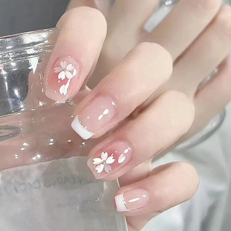 Set of 24 short square-shaped artificial nails from LAQTA, showcasing a variety of stylish nail designs and finishes.