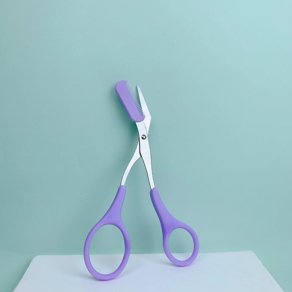 Pink eyebrow trimming scissors by LAQTA with sharp blades, designed for precise eyebrow shaping and grooming.