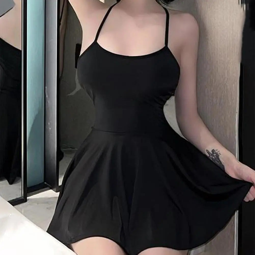 Black pleated micro dress by LAQTA featuring a fitted design and stylish pleats, shown on a mannequin.