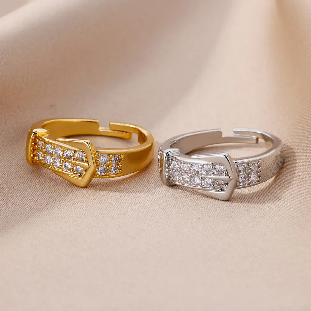 Elegant LAQTA women's rings featuring intricate designs and polished finishes, showcased on a neutral background.