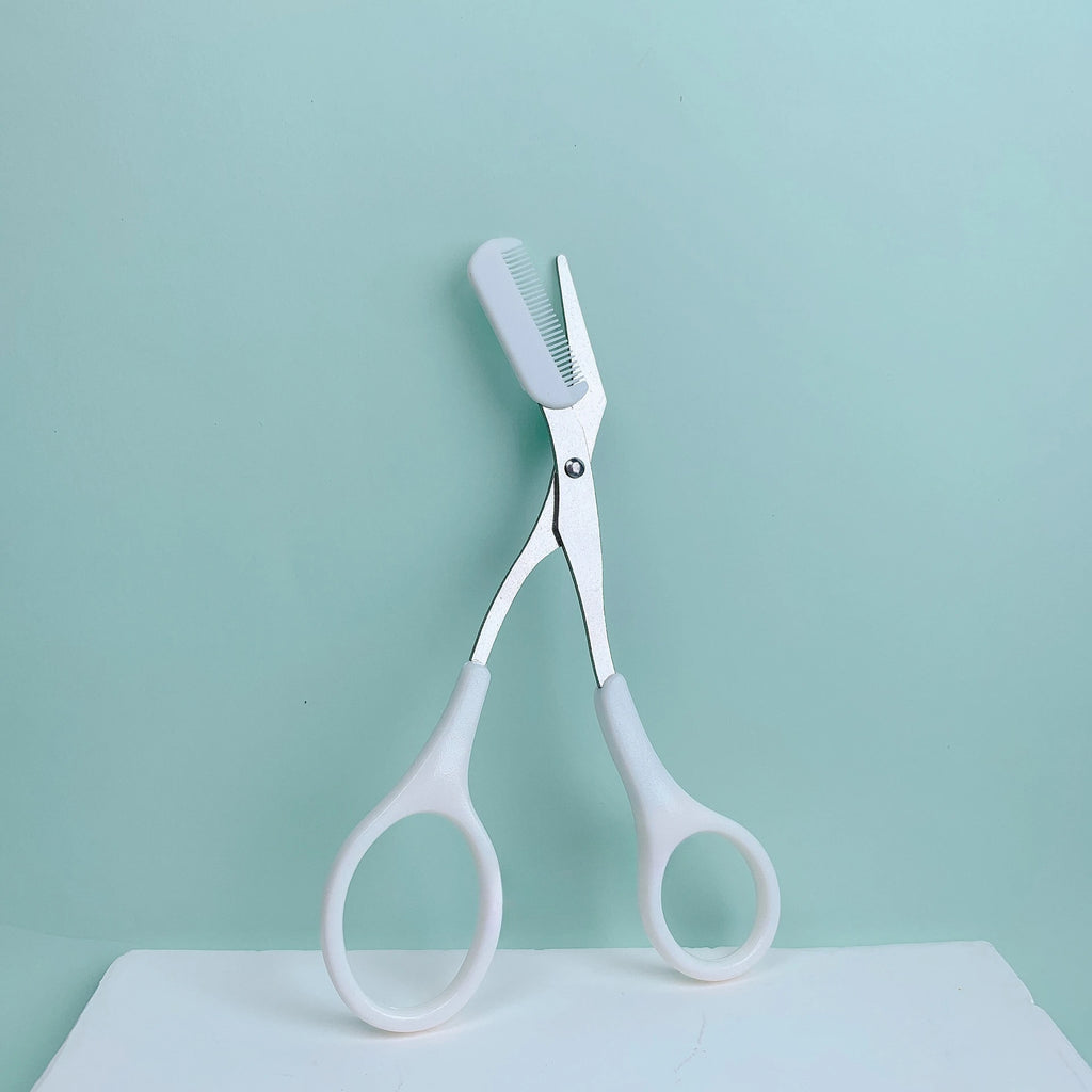 Pink eyebrow trimming scissors by LAQTA with sharp, precise blades for grooming eyebrows.