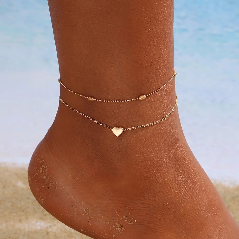 Silver metal pendant anklet from LAQTA featuring intricate design and delicate chain for stylish ankle jewelry.