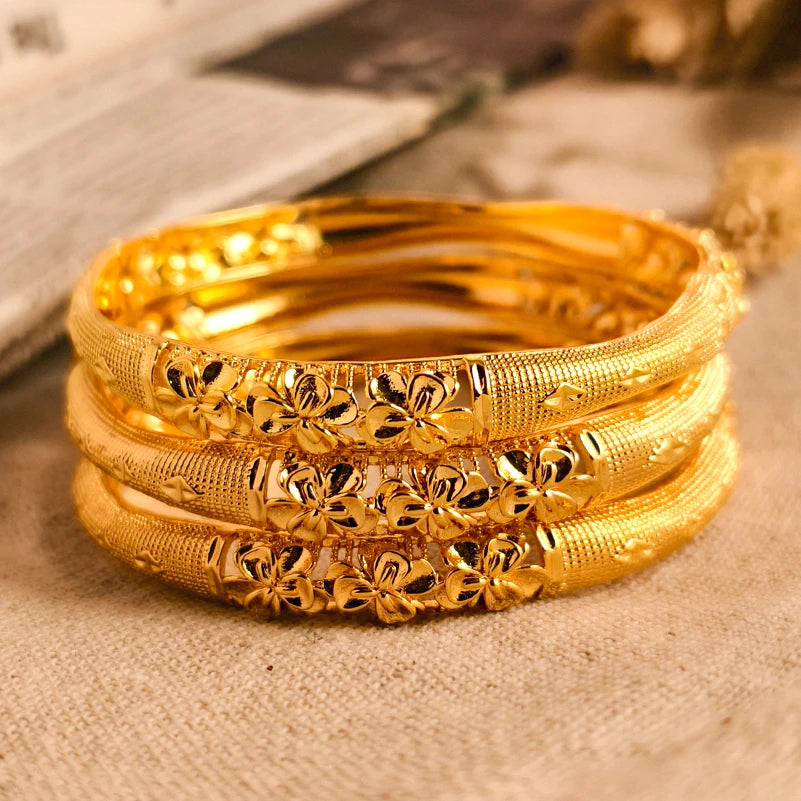 LAQTA 24k Dubai gold color bangles featuring intricate design and shiny finish, traditional jewelry accessory for women.