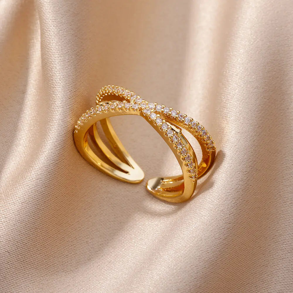 Elegant women's rings by LAQTA featuring silver bands and intricate designs, displayed on a neutral background.