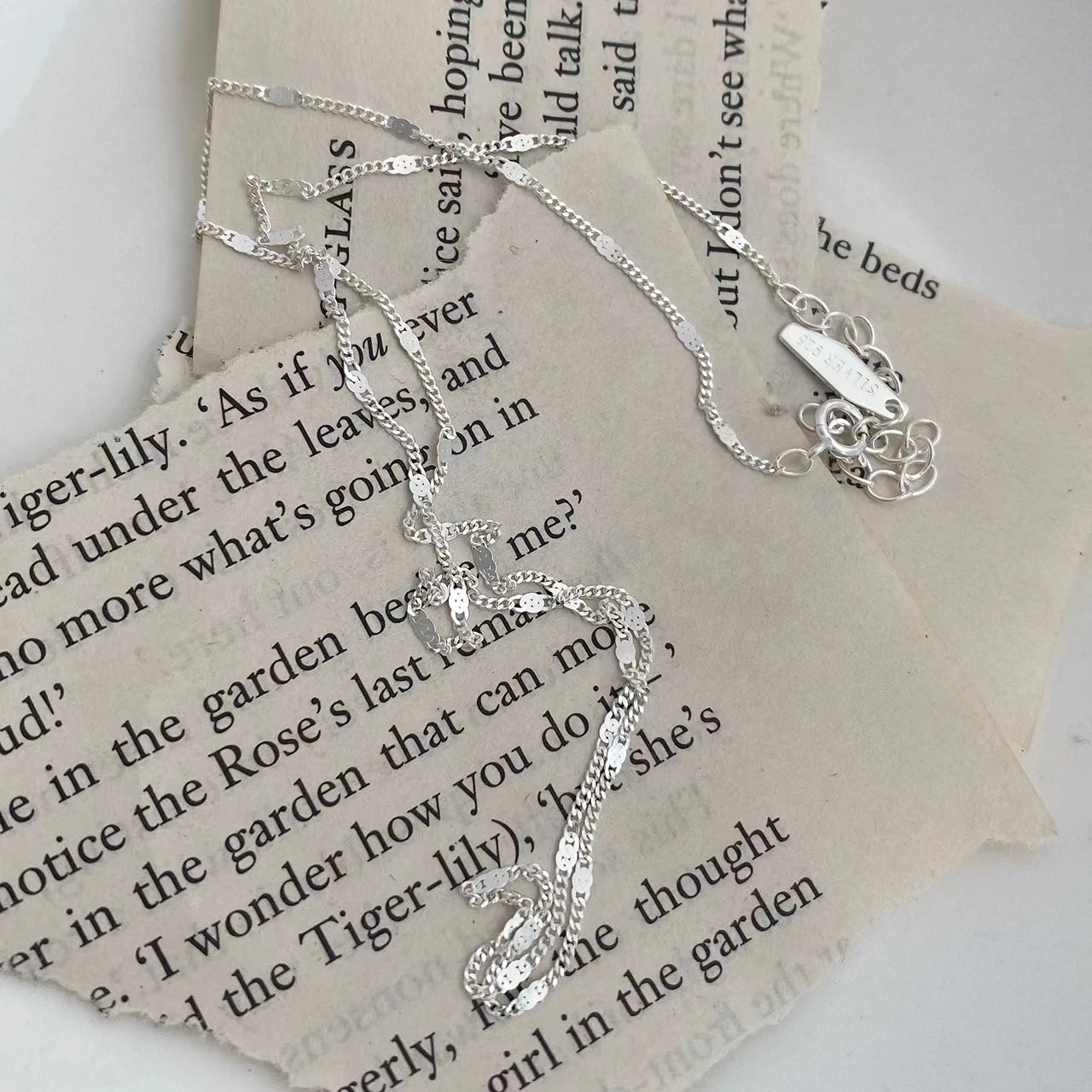 Sterling silver women's necklace with delicate chain, elegant jewelry accessory by LAQTA, shown on a neutral background.