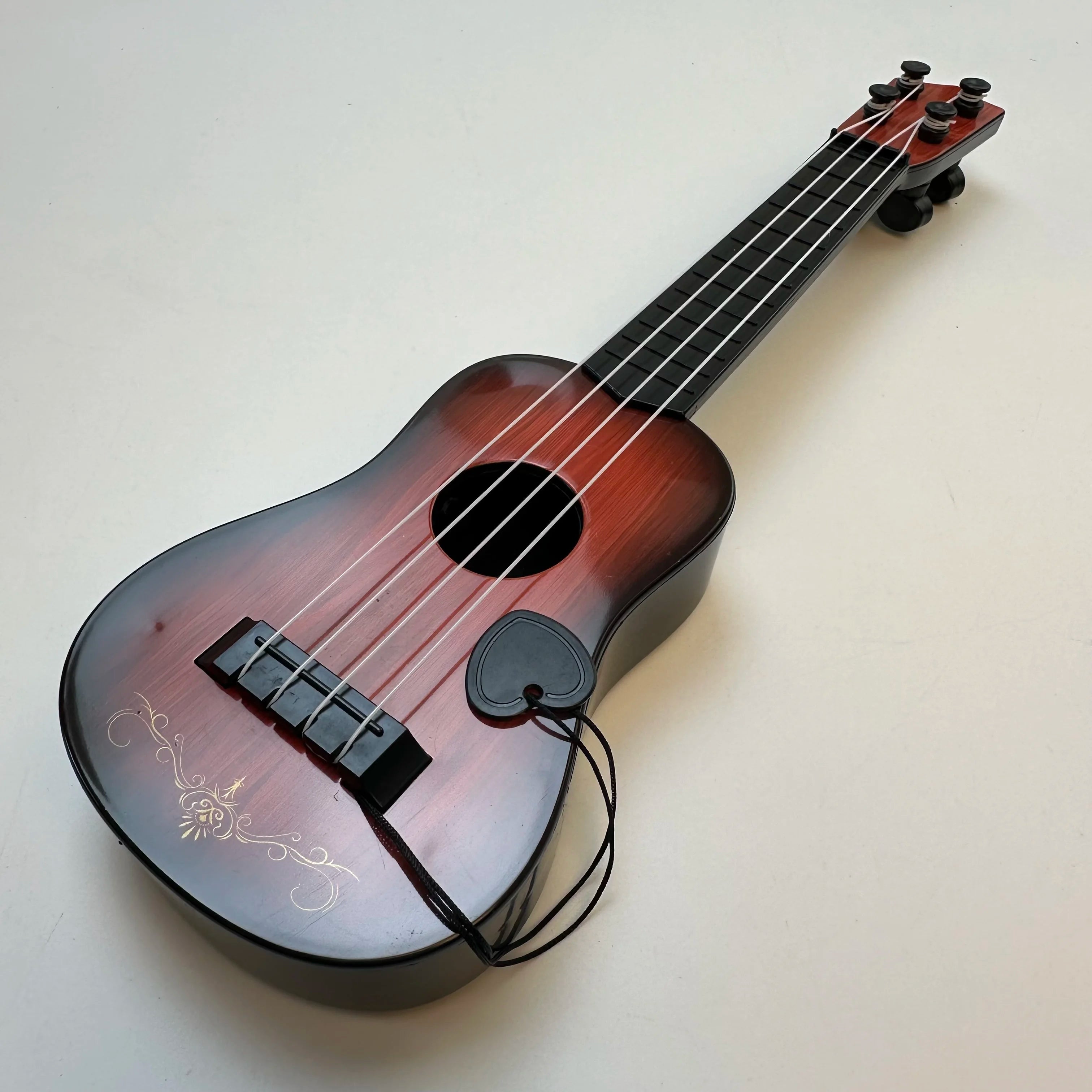 Children's guitar toy by LAQTA, music-oriented design with colorful plastic body and strings for young kids to play and learn music.