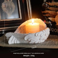 White Angel Candle Holder by LAQTA, featuring a detailed angel design in ceramic with a classical style.