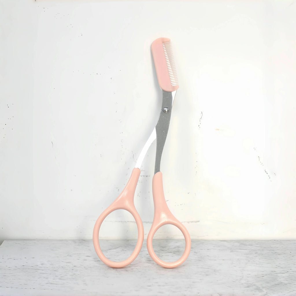 Pink eyebrow trimming scissors by LAQTA with sharp blades and ergonomic handles for precise eyebrow grooming.