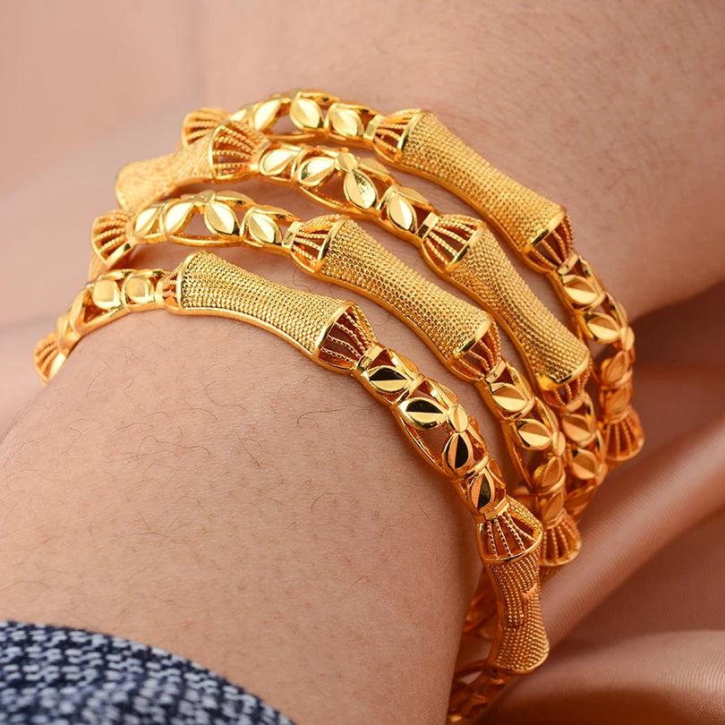 24k Dubai gold color bangles by LAQTA, featuring shiny gold-tone metal with intricate design details, perfect for traditional jewelry.