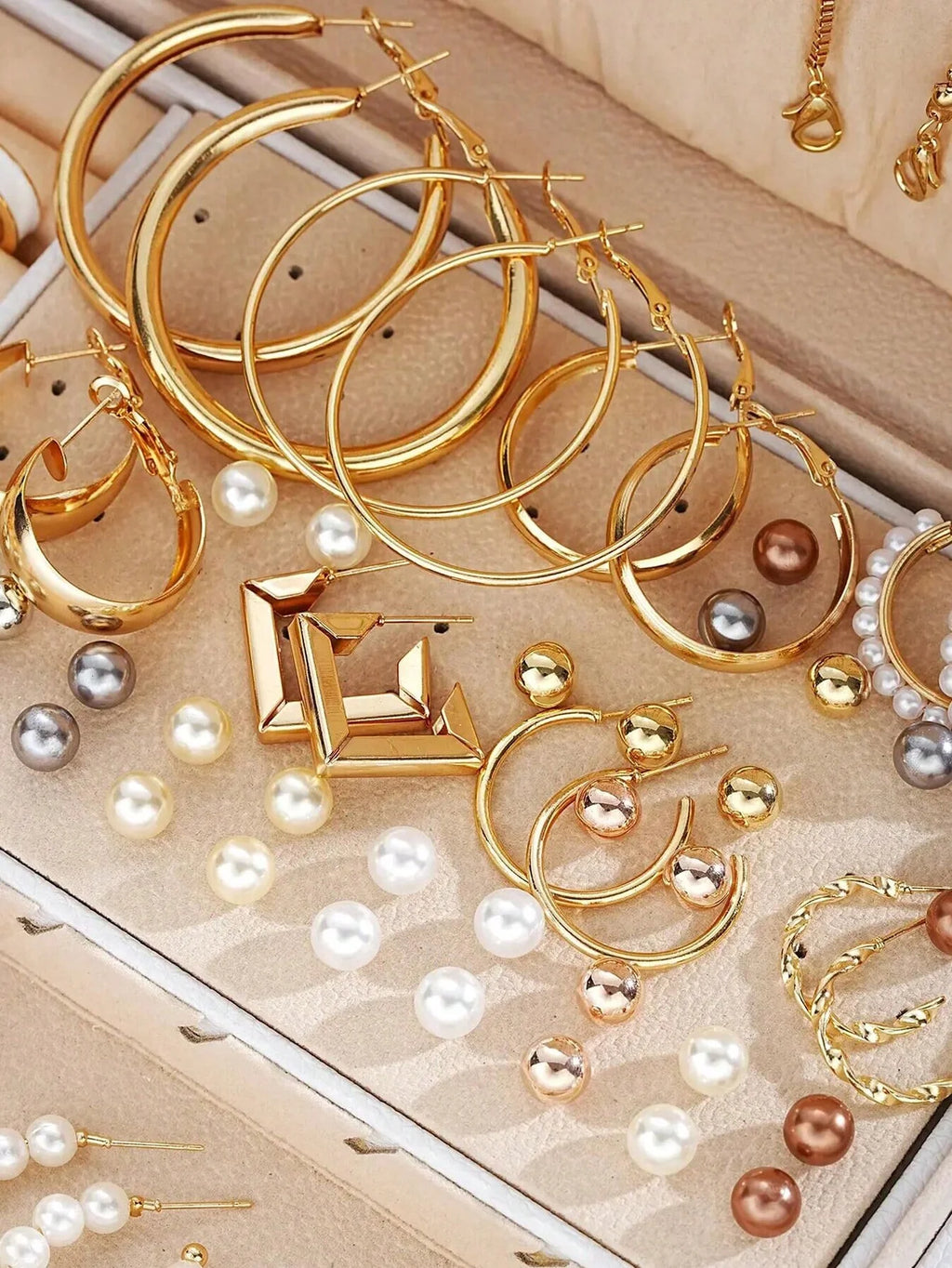 Elegant multi-pearl earrings by LAQTA featuring shimmering pearls and intricate metalwork, displayed on a white background.