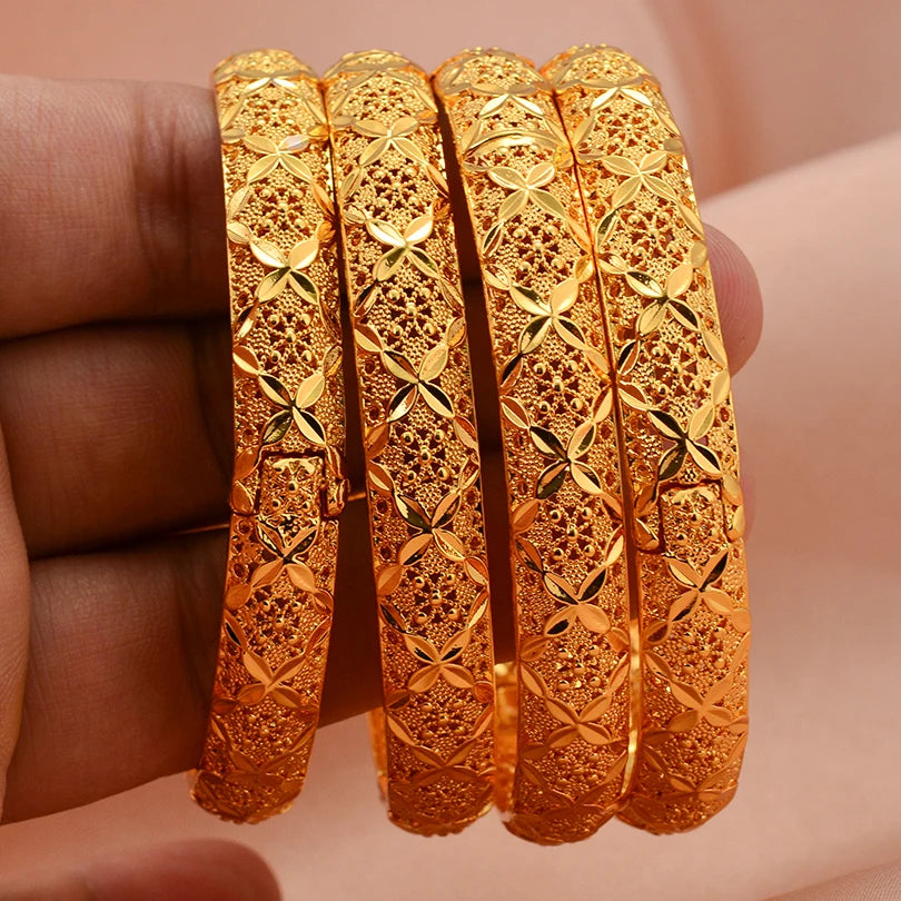 Elegant 24k Dubai gold color bangles by LAQTA, showcasing shiny gold finish and traditional design on a neutral background.