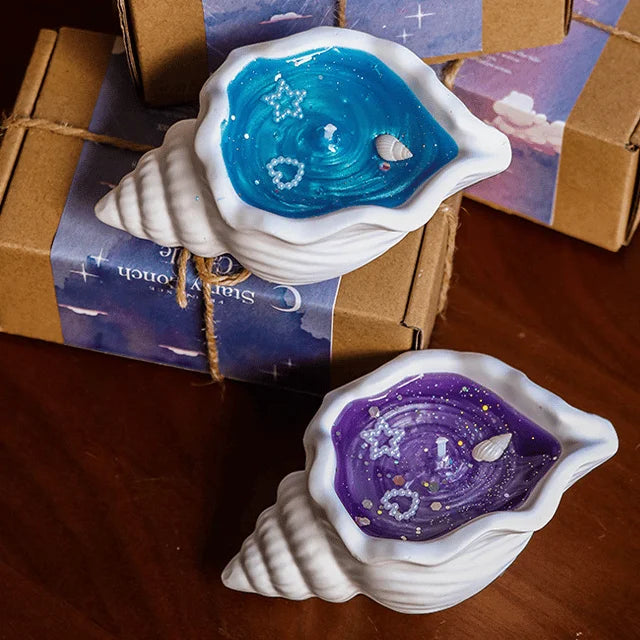 LAQTA sea shell aromatherapy candle with a natural shell design and soothing flame, perfect for relaxation and ambiance.