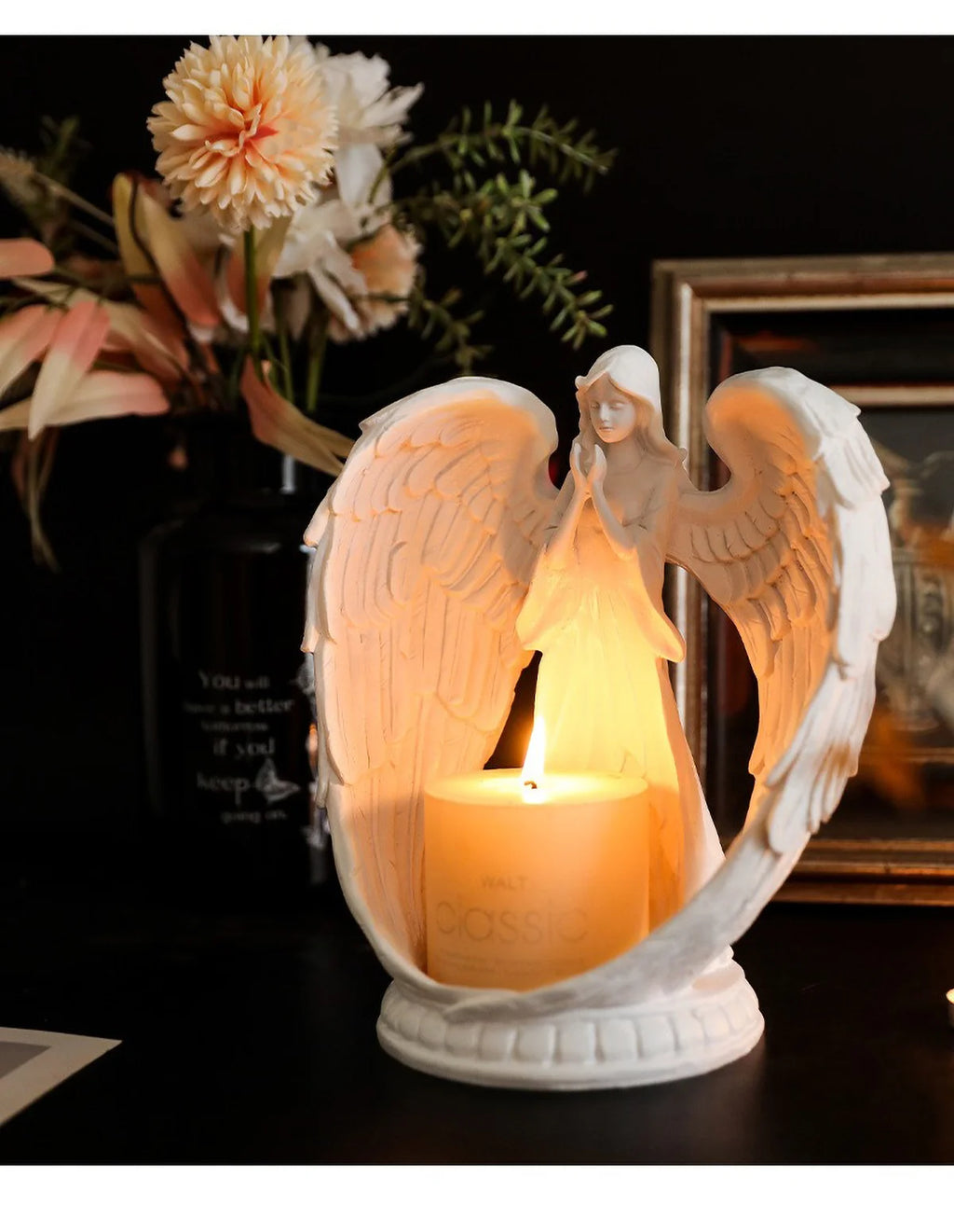 White angel candle holder by LAQTA featuring a detailed angel figure with a hollow interior for holding a candle.