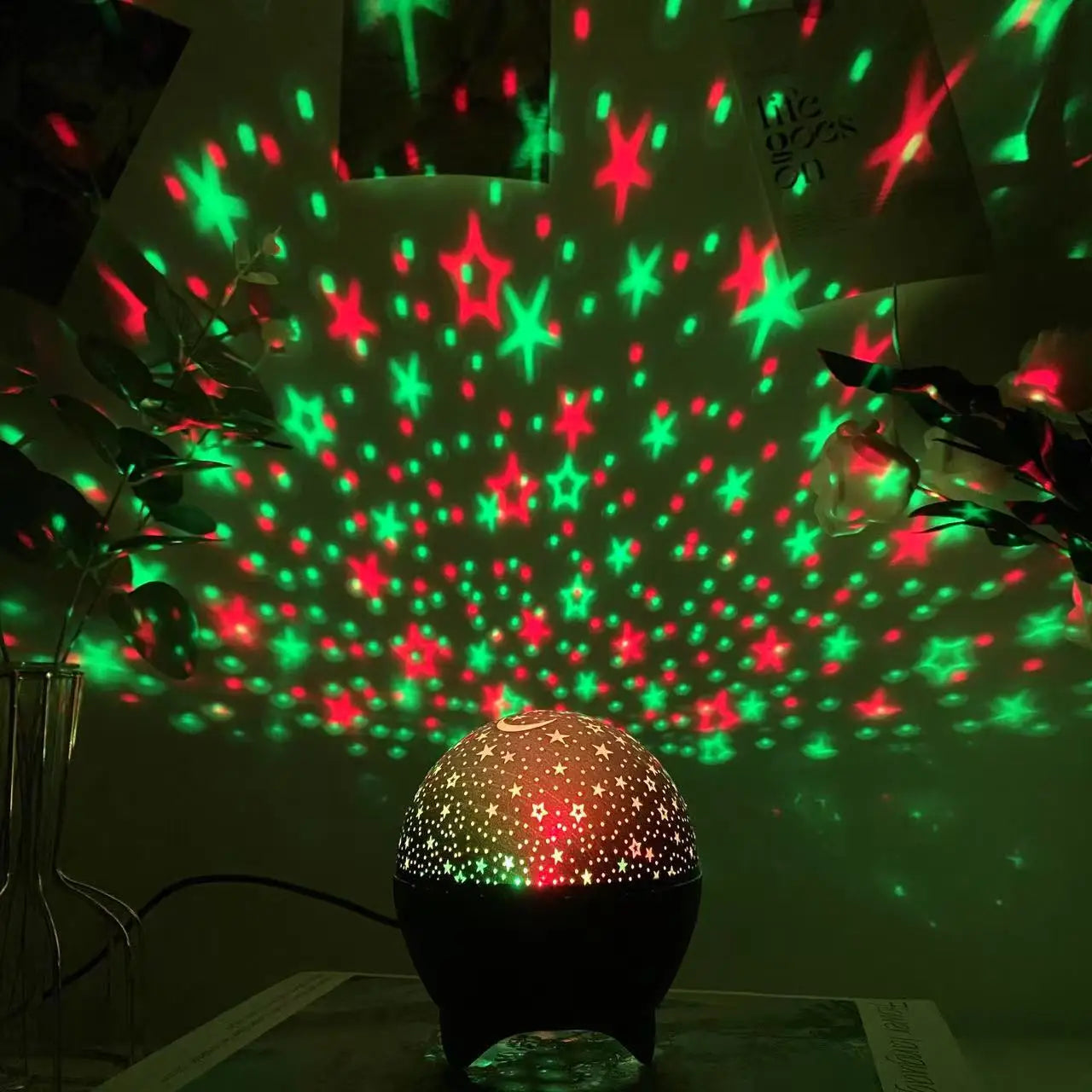 LAQTA Starry Sky Moon Projector LED night light displaying a moon and starry sky scene for relaxing bedroom ambiance.
