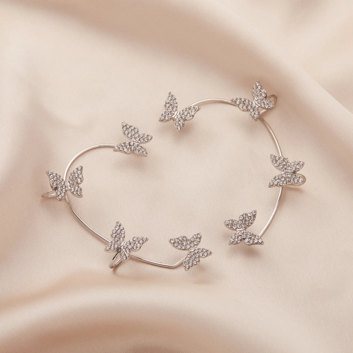 LAQTA Korean style butterfly ear clips featuring delicate butterfly designs on silver-toned metal for a stylish accessory.