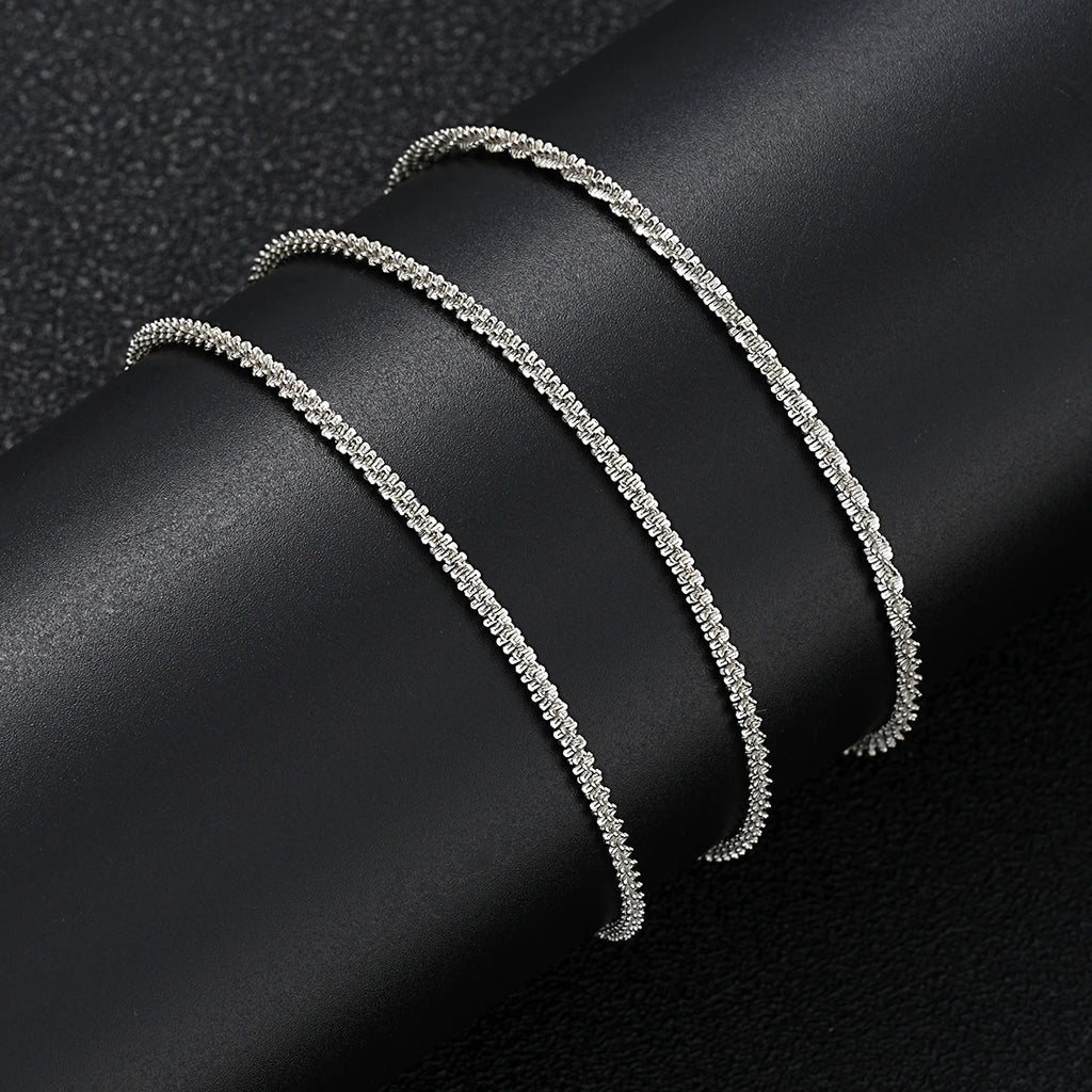 Silver metal pendant anklet by LAQTA featuring intricate design and delicate chain suitable for stylish ankle adornment.