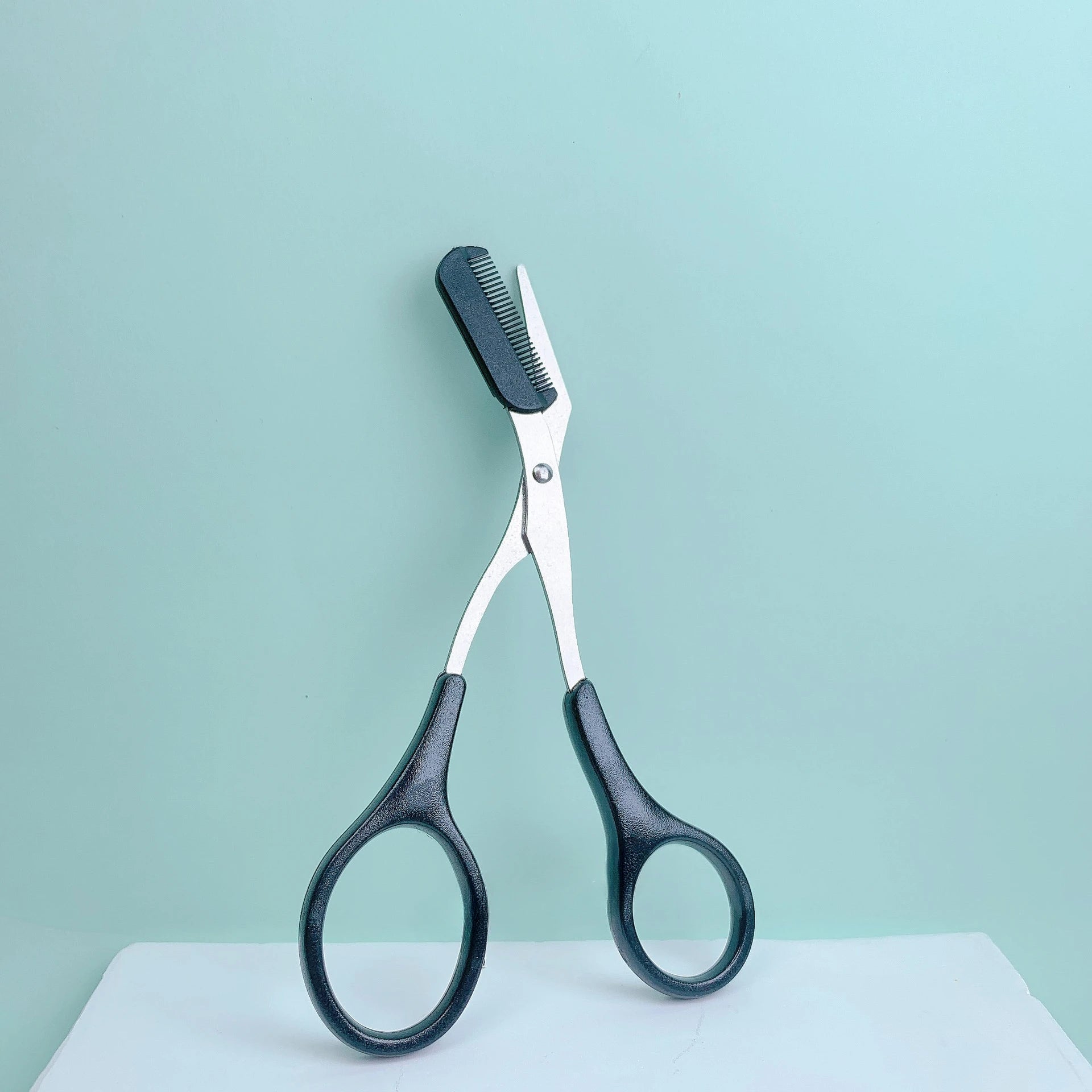Pink eyebrow trimming scissors by LAQTA, featuring sharp, precise blades for grooming and shaping eyebrows.