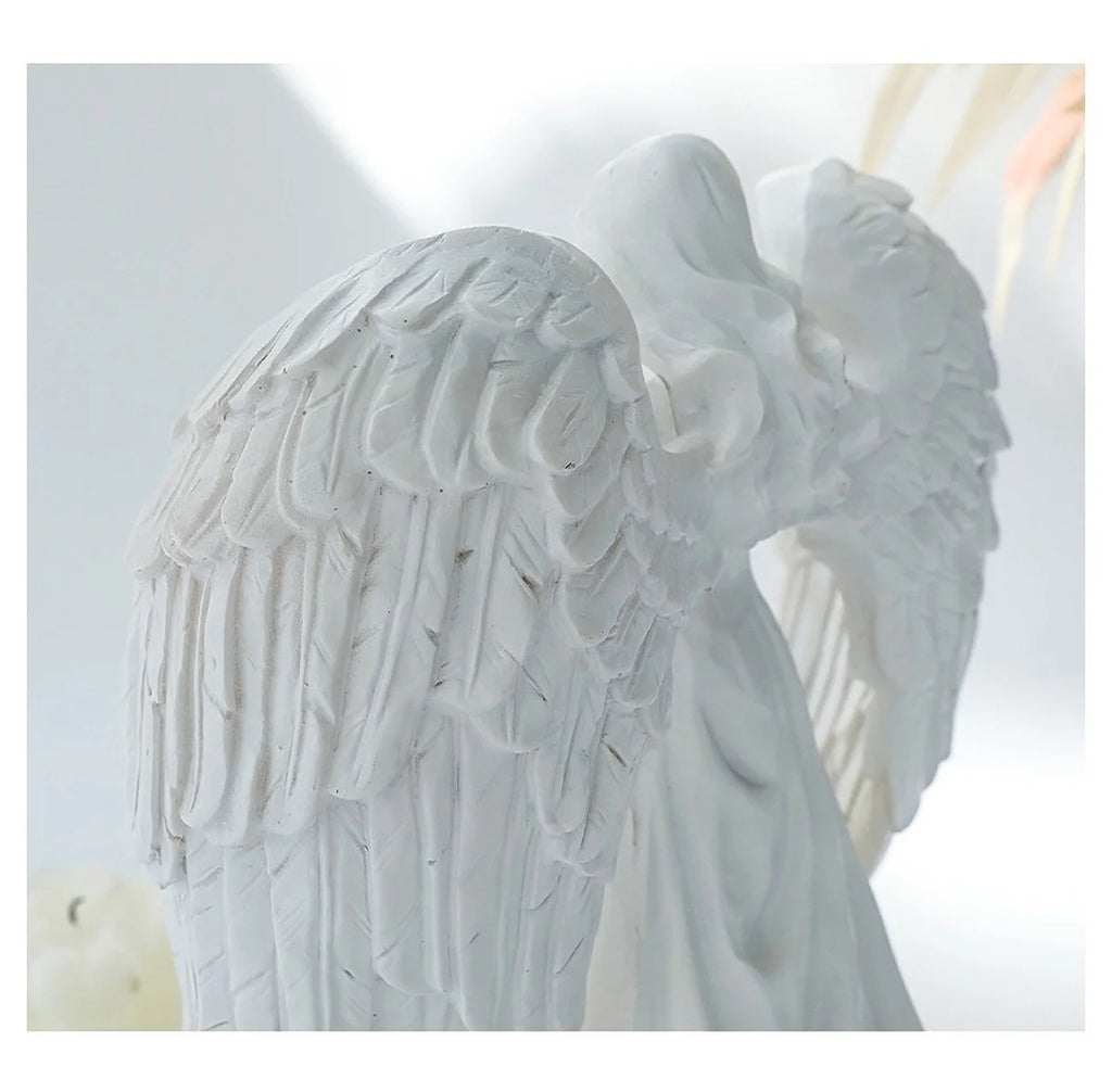 White angel candle holder by LAQTA featuring a detailed angel figure with outstretched wings and a pedestal base.