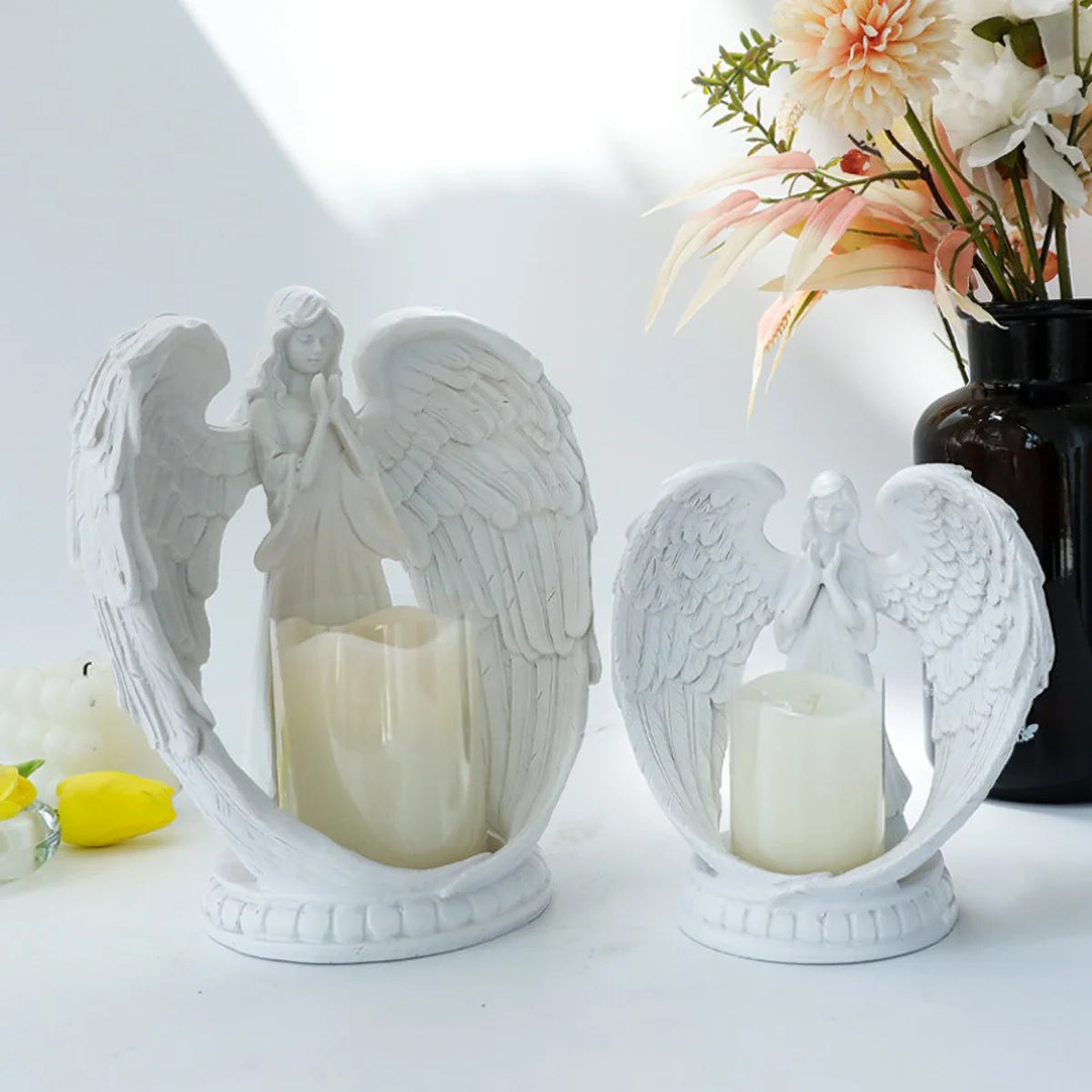 White angel candle holder by LAQTA featuring a detailed angel figure with a hollow center for a candle.