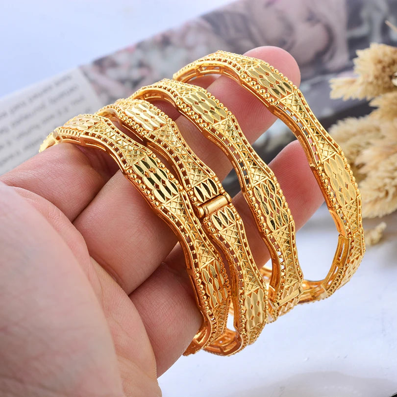 24k Dubai gold color bangles by LAQTA, showcasing shiny gold-tone traditional jewelry with intricate designs.