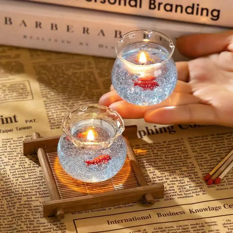 LAQTA Bubble Fish Tank Goldfish aromatherapy candle in glass container with decorative fish and water-inspired design.