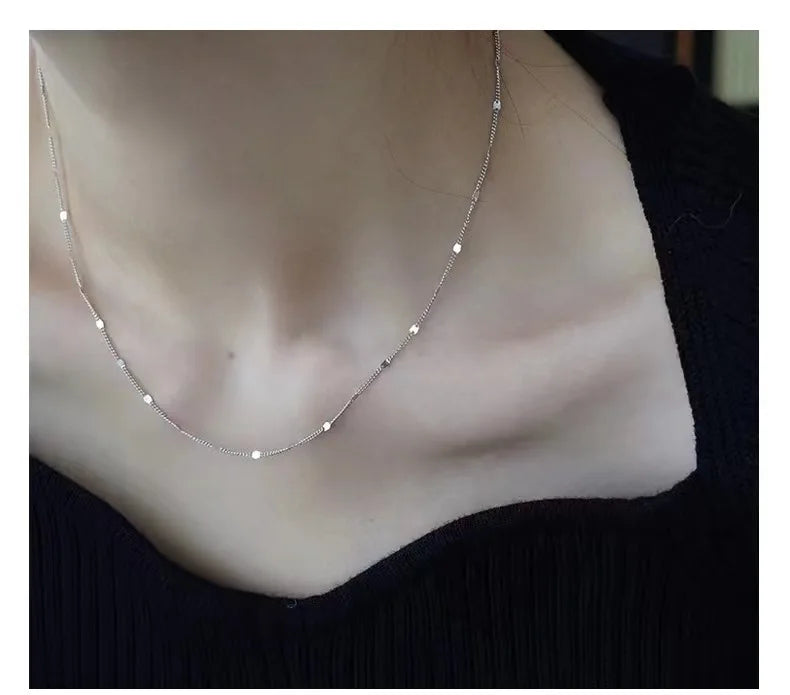 Sterling silver women's necklace with delicate chain and pendant, showcasing elegant jewelry design by LAQTA