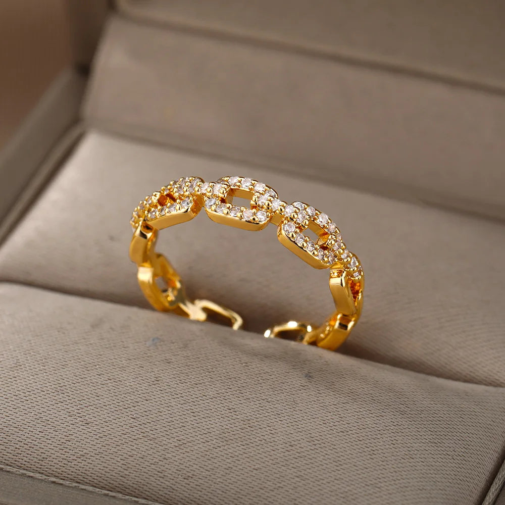 Elegant women's rings by LAQTA featuring intricate designs and shiny finishes, displayed on a neutral background.