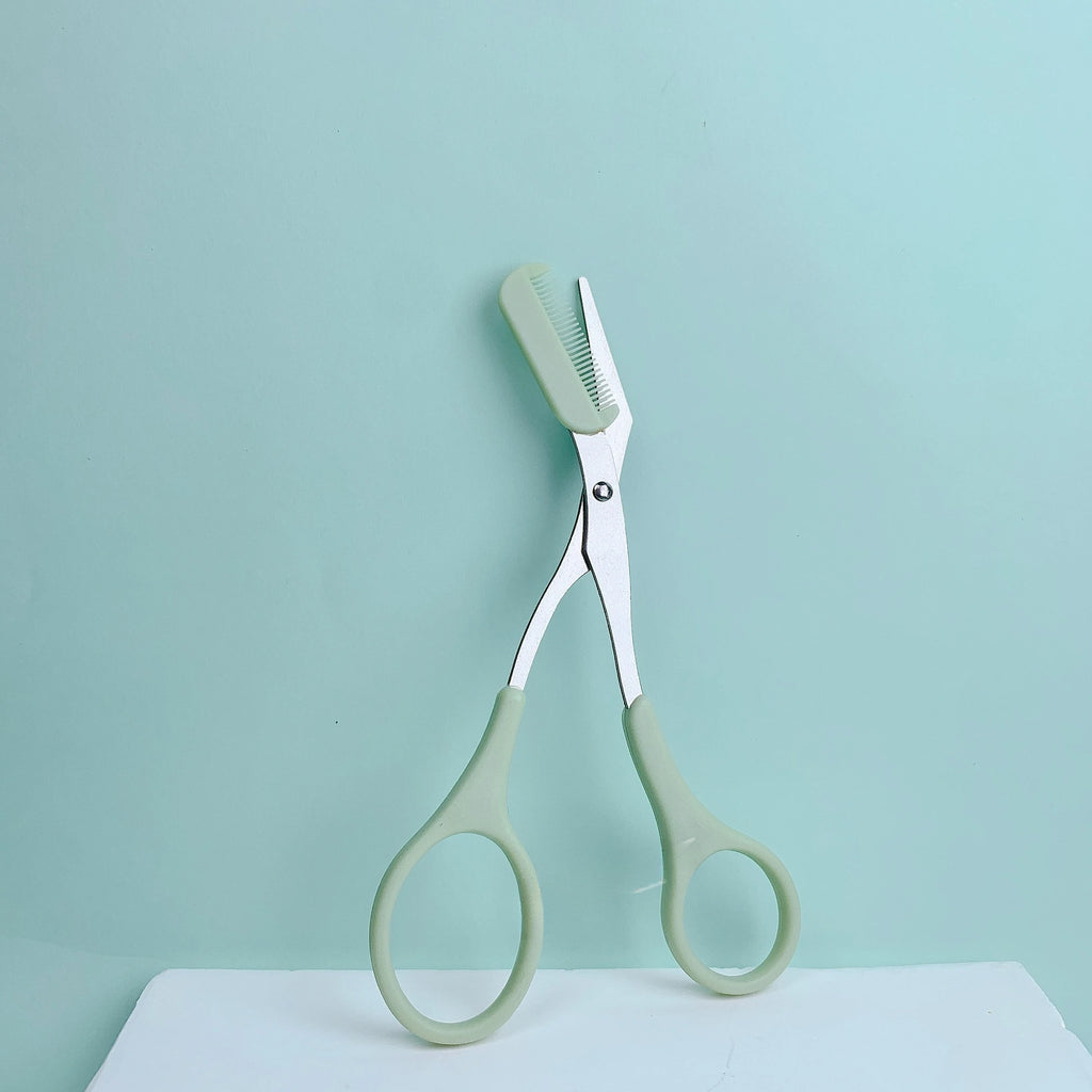 Pink eyebrow trimming scissors by LAQTA with sharp blades for precise eyebrow grooming and shaping.