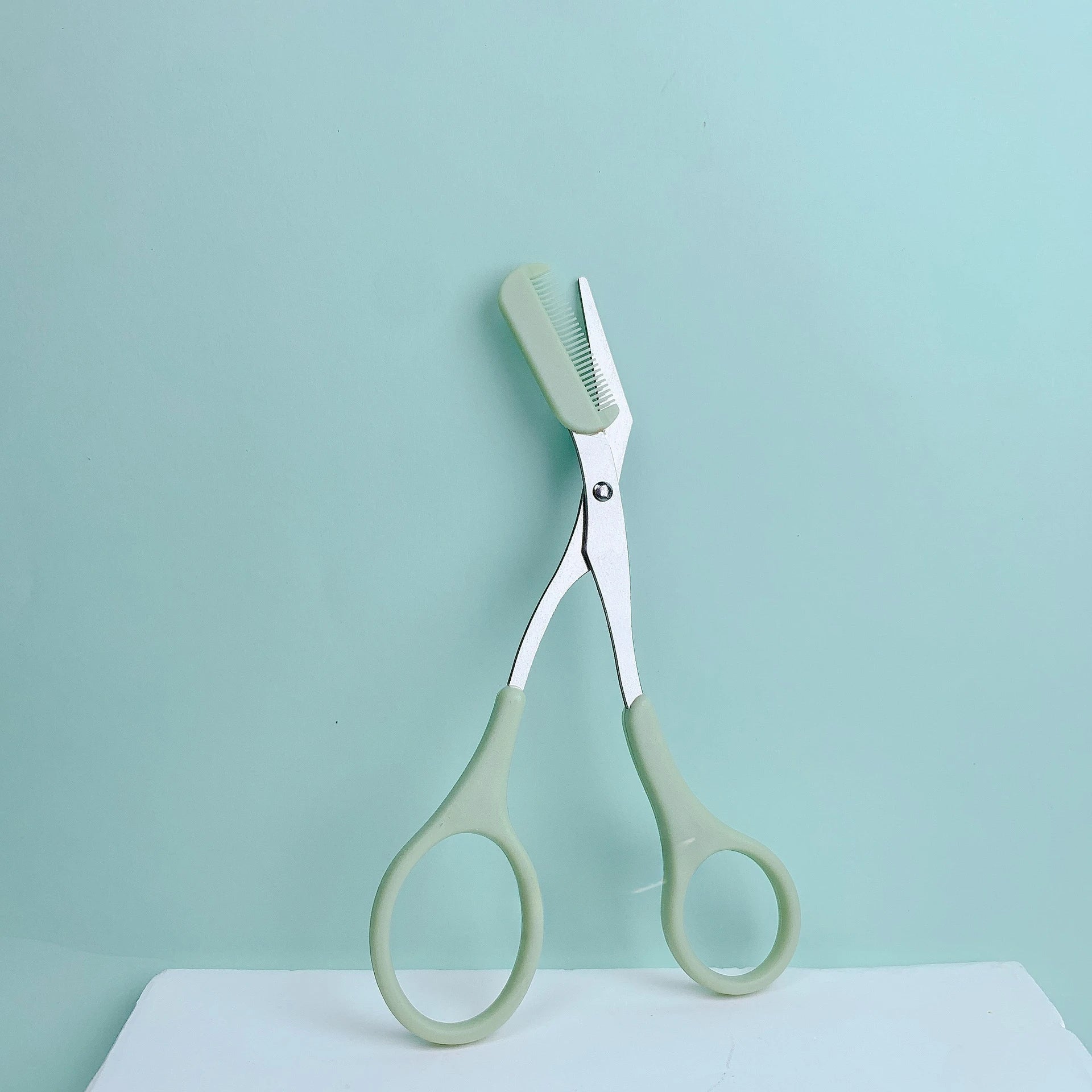 Pink eyebrow trimming scissors by LAQTA with sharp blades for precise eyebrow grooming and shaping.